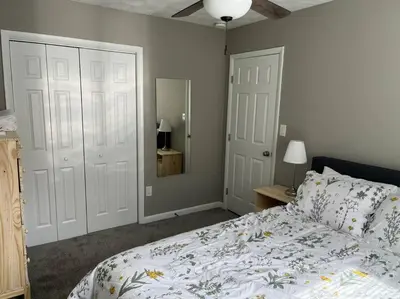 a bedroom with a bed and two white doors at Carter #4 Two bedroom unit near Xavier Downtown in Cincinnati