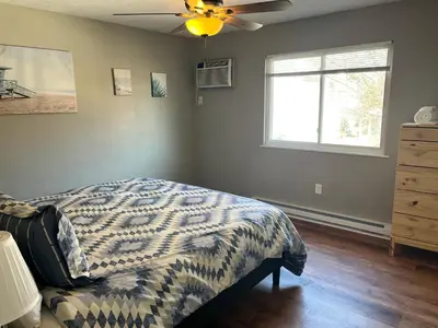 a bedroom with a bed and a window at Carter #4 Two bedroom unit near Xavier Downtown in Cincinnati