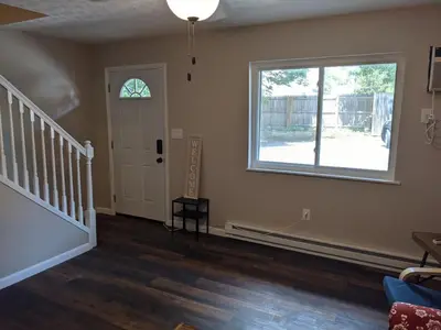 an empty living room with a staircase and a window at Carter #5 Two bedroom unit near Xavier Downtown in Cincinnati