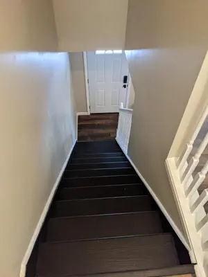 a stairway leading up to a white door at Carter #5 Two bedroom unit near Xavier Downtown in Cincinnati