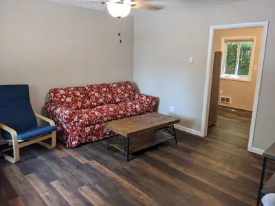 a living room with a couch and a table and a chair at Carter #5 Two bedroom unit near Xavier Downtown in Cincinnati