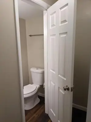 a bathroom with a toilet and a white door at Carter #5 Two bedroom unit near Xavier Downtown in Cincinnati