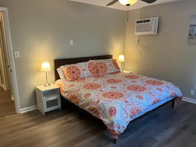 a bedroom with a bed and a night stand with two lamps at Carter #6 Two Bedroom Apartment near Xavier in Cincinnati