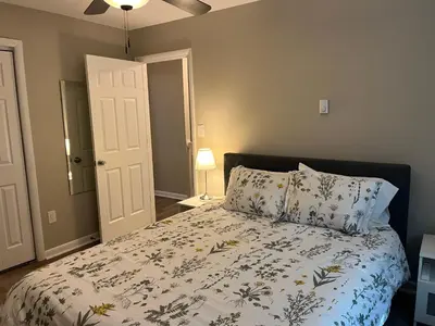 a bedroom with a bed with a floral bedspread and pillows at Carter #6 Two Bedroom Apartment near Xavier in Cincinnati