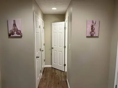 a hallway with two white doors and two paintings at Carter #6 Two Bedroom Apartment near Xavier in Cincinnati