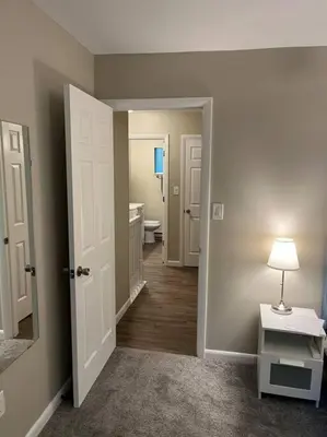 a hallway with a bathroom with a toilet and a sink at Carter #6 Two Bedroom Apartment near Xavier in Cincinnati