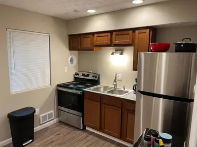 a kitchen with a stainless steel refrigerator and a sink at Carter #6 Two Bedroom Apartment near Xavier in Cincinnati