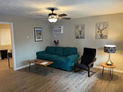 a living room with a blue couch and a table at Carter #6 Two Bedroom Apartment near Xavier in Cincinnati