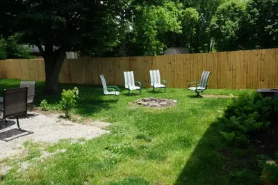 a group of chairs in a yard next to a fence at Harper Two Bedroom House in Historic Loveland in Loveland