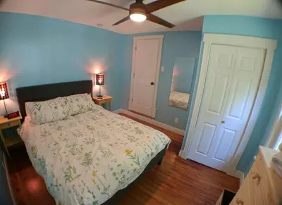 a bedroom with a bed and a ceiling fan at Harper Two Bedroom House in Historic Loveland in Loveland