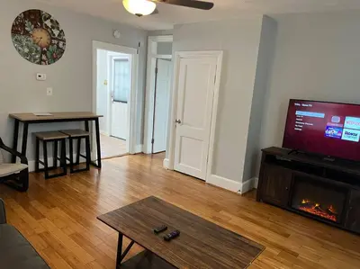 a living room with a flat screen tv and a fireplace at Main, Three Bedroom House in Historic Loveland in Loveland