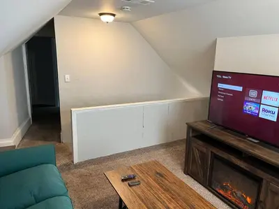 a living room with a couch and a large screen tv at Main, Three Bedroom House in Historic Loveland in Loveland