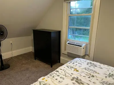 a bedroom with a bed and a dresser and a window at Main, Three Bedroom House in Historic Loveland in Loveland