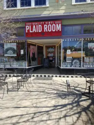 a patio with chairs and tables in front of a building at Main, Three Bedroom House in Historic Loveland in Loveland