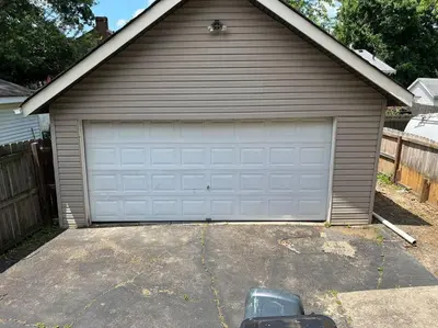 a house with a garage door in a driveway at Warren 1 Bedroom Unit near Xavier Downtown in Bellevue