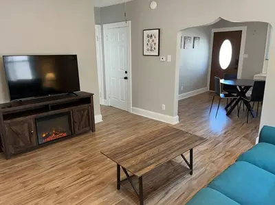a living room with a tv and a fireplace at Warren 1 Bedroom Unit near Xavier Downtown in Bellevue