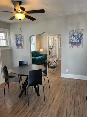 a living room with a table and chairs and a couch at Warren 1 Bedroom Unit near Xavier Downtown in Bellevue