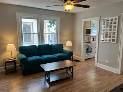 a living room with a blue couch and a coffee table at Warren 1 Bedroom Unit near Xavier Downtown in Bellevue