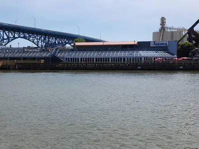 a stadium next to a river with a bridge at Penthouse Loft In The Flats in Cleveland