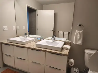 a bathroom with two sinks and a large mirror at Penthouse Loft In The Flats in Cleveland