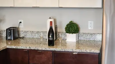 a bottle of wine sitting on top of a kitchen counter at Penthouse Loft In The Flats in Cleveland