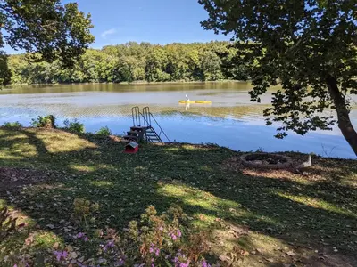 a lake with a boat in the water at River Log Cabins in Waterville