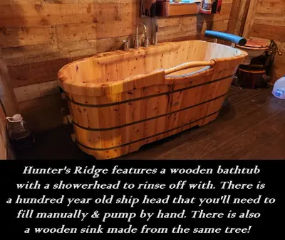 a wooden bath tub sitting in a room at River Log Cabins in Waterville