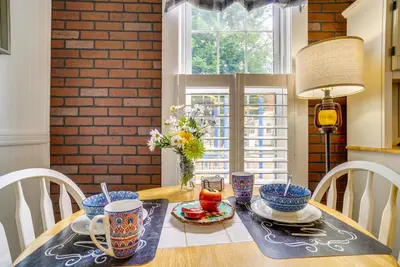 a dining room table with blue and white dishes on it at Quaint Mt Vernon Cottage Near Historic Dtwn! in Mount Vernon