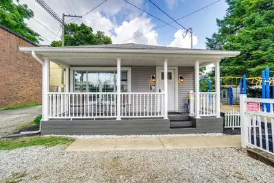 a small house with a porch and a playground at Quaint Mt Vernon Cottage Near Historic Dtwn! in Mount Vernon