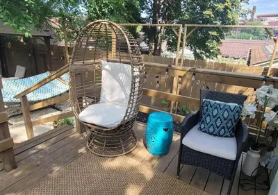a patio with two chairs and a swing on a deck at Tremont! 7 min to downtown Cleveland in Cleveland