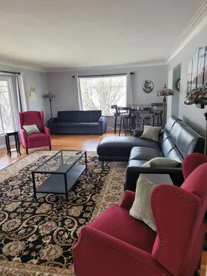 a living room with couches and a table at dock, game room, bar and private river view patio in Toledo