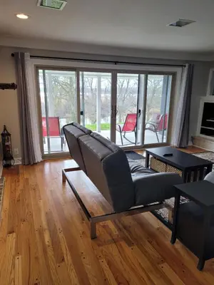 a living room with a couch and a table at dock, game room, bar and private river view patio in Toledo
