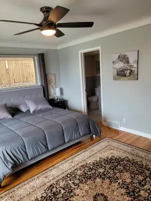 a bedroom with a bed and a ceiling fan at dock, game room, bar and private river view patio in Toledo