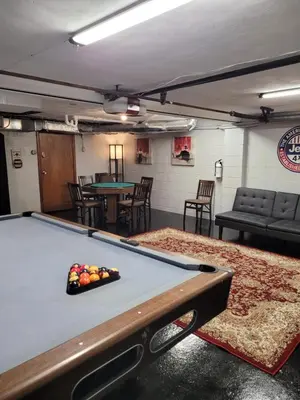 a pool table in a room with tables and chairs at dock, game room, bar and private river view patio in Toledo