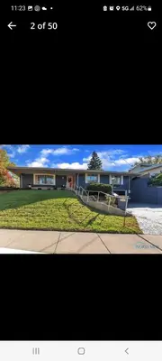 a picture of a large house with a driveway at dock, game room, bar and private river view patio in Toledo