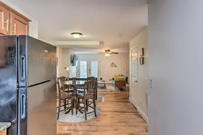a kitchen with a refrigerator and a table with chairs at Welcoming Ohio Getaway Less Than 9 Mi to Dtwn Toldeo! in Toledo