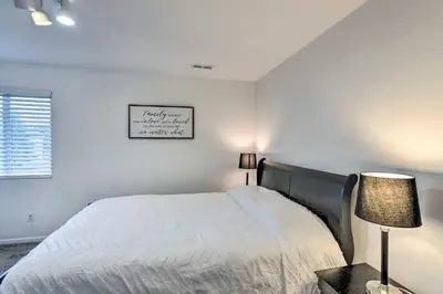 a white bedroom with a bed and a lamp at Welcoming Ohio Getaway Less Than 9 Mi to Dtwn Toldeo! in Toledo