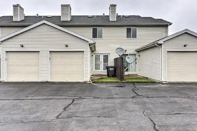 a house with two garage doors and a driveway at Welcoming Ohio Getaway Less Than 9 Mi to Dtwn Toldeo! in Toledo