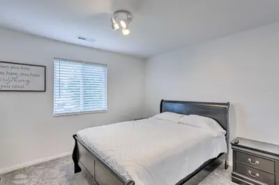 a white bedroom with a bed and a window at Welcoming Ohio Getaway Less Than 9 Mi to Dtwn Toldeo! in Toledo