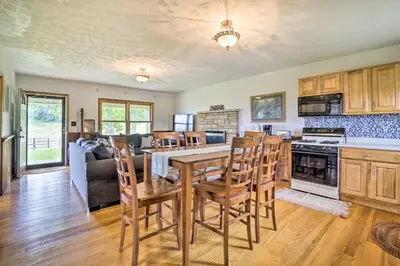 a kitchen and living room with a table and chairs at McArthur Cabin Peaceful Getaway on Farm! in McArthur