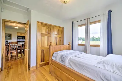 a bedroom with a bed and a dining room at McArthur Cabin Peaceful Getaway on Farm! in McArthur