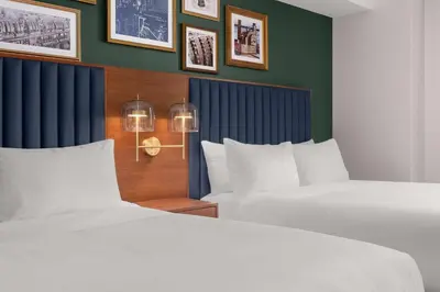 two beds sitting next to each other in a bedroom at Hotel Ardent Dayton Downtown, Tapestry Collection By Hilton in Dayton