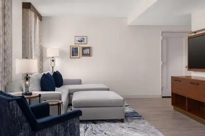 a living room with a couch and a tv at Hotel Ardent Dayton Downtown, Tapestry Collection By Hilton in Dayton