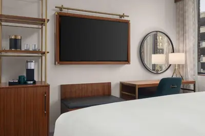 a hotel room with a flat screen tv and a bed at Hotel Ardent Dayton Downtown, Tapestry Collection By Hilton in Dayton