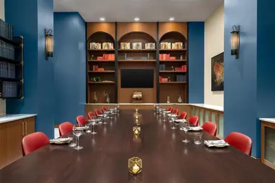 a large conference room with a long table and red chairs at Hotel Ardent Dayton Downtown, Tapestry Collection By Hilton in Dayton