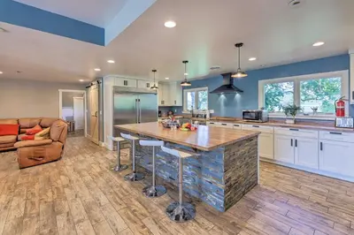 a kitchen with a large island in the middle at Peaceful Lebanon FarmhouseandRanch with Pool! in Lebanon