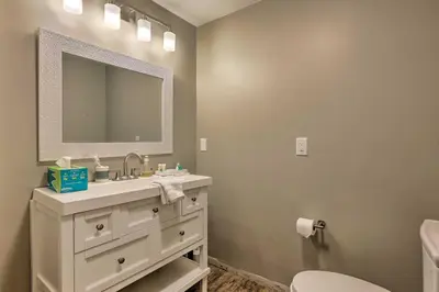 a bathroom with a white sink and a mirror at Peaceful Lebanon FarmhouseandRanch with Pool! in Lebanon