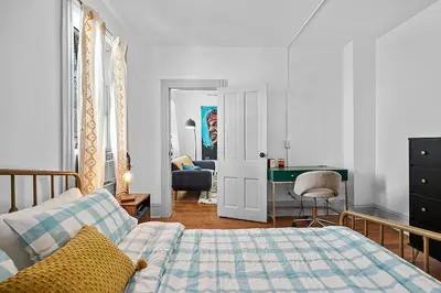 a bedroom with a bed and a desk at Center of Little Italy #1 in Cleveland