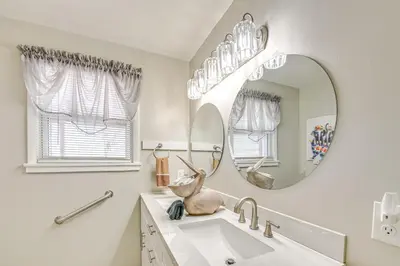 a bathroom with a sink and a mirror at Welcoming Kentucky Home with Sprawling Views! in Corinth