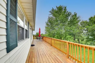 a porch of a house with a wooden deck at Welcoming Kentucky Home with Sprawling Views! in Corinth